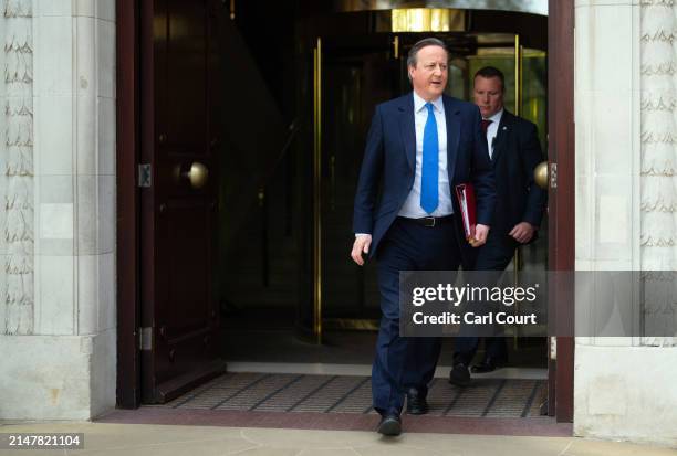 Britain's Foreign Secretary David Cameron leaves Millbank studios after conducting a series of television and radio interviews on April 15, 2024 in...