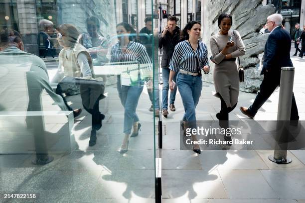 Financial industry workers and the sculpture entitled 'City Wing' on Threadneedle Street in the City of London, the capital's financial district , on...