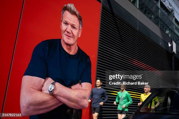 As lunchtime runners pass-by, TV chef Gordon Ramsay is seen on a giant billboard outside his 'Bread Street Kitchen & Bar - The City' restaurant in...