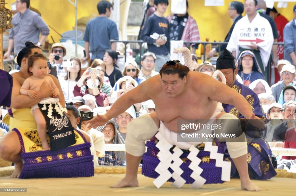 Japanese Ritual Sumo Sumo grand champion Terunofuji, accompanied by his son, performs a ...