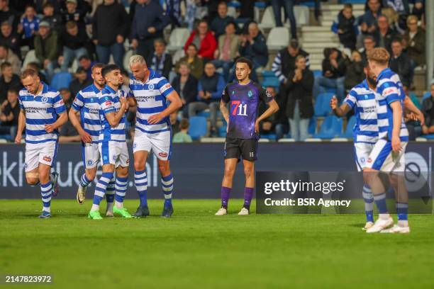 Devon Koswal of Telstar is looking dejected, while Basar Onal of De Graafschap and Ralf Seuntjes of de Graafschap are celebrating their teams first...