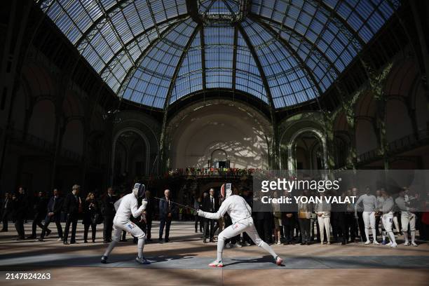 French national fencing squad show their skills during French president's visit to Le Grand Palais, in Paris, on April 15 100 days ahead of the Paris...