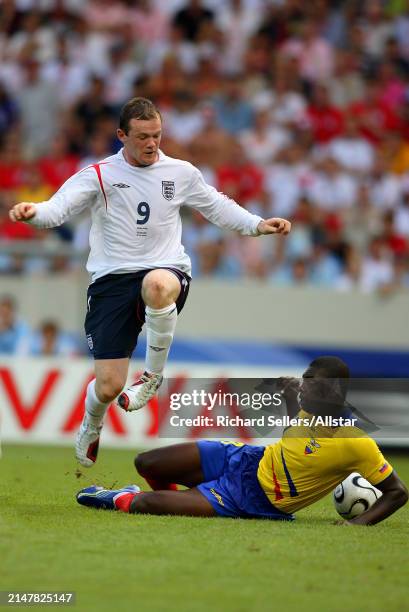 June 25: Wayne Rooney of England and Giovanny Espinoza of Ecuador challenge during the FIFA World Cup Finals 2006 Round Of 16 match between England...