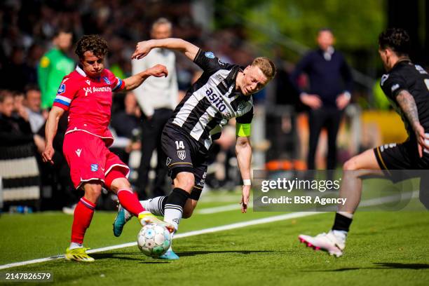 Mats Kohlert of sc Heerenveen is challenged by Brian De Keersmaecker of Heracles Almelo during the Dutch Eredivisie match between Heracles Almelo and...