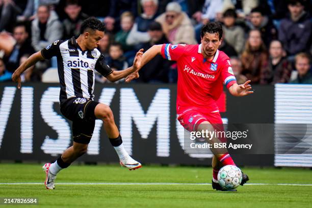 Frederik Oppegard of Heracles Almelo challenges Thom Haye of sc Heerenveen during the Dutch Eredivisie match between Heracles Almelo and sc...