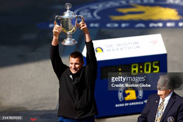 Boston, MA Boston Marathon Grand Marshall and former New England Patriot Rob Gronkowski poses with the trophy at the finish line of the Boston...