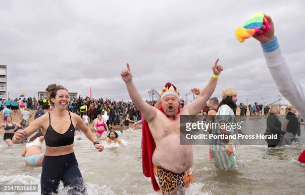 People enter the water during the 36th annual Lobster Dip in Old Orchard Beach on Monday, January 1, 2024. About 600 people took part in the cold...
