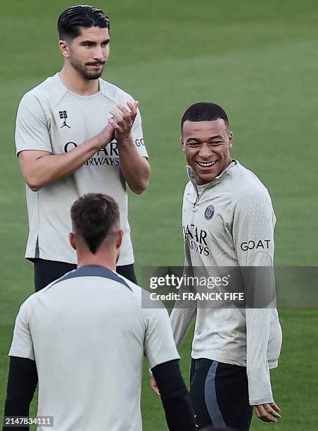 Paris Saint-Germain's French forward Kylian Mbappe reacts during a training session on the eve of their UEFA Champions League quarter-final second...