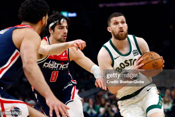 Boston, MA Boston Celtics guard Svi Mykhailiuk drives with pressure from Washington Wizards forward Deni Avdija in the first quarter at TD Garden.