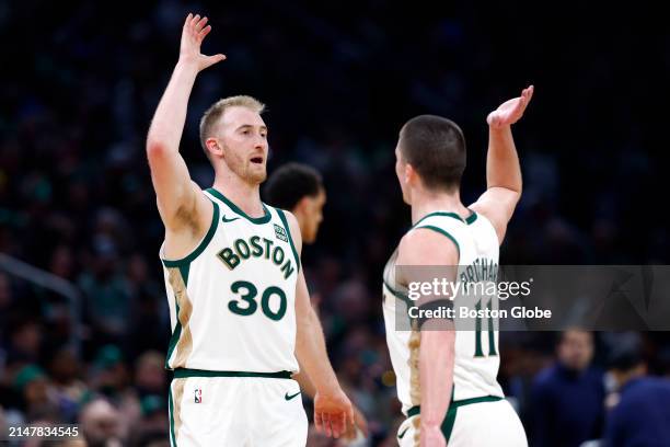 Boston, MA Boston Celtics forward Sam Hauser and guard Payton Pritchard high-five during a timeout in the third quarter.