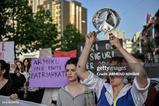 Woman shouts slogans and hits a pan during a protest in Pristina on April 15 after the femicide of a 21-year-old woman and demanding a tougher policy...
