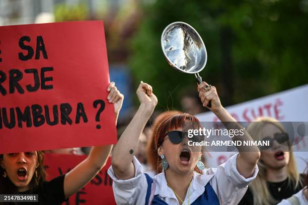 Woman shouts slogans and hits a pan during a protest in Pristina on April 15 after the femicide of a 21-year-old woman and demanding a tougher policy...