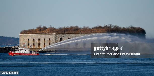 Portland fireboat sprays water as it passes by Fort Gorges in Portland Harbor Friday, March 8, 2024.