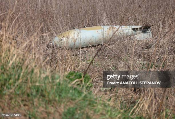 This photograph taken on April 15 shows an unexploded Russian FAB-500 aerial bomb in a field near the village of Ocheretyne not far from Avdiivka...