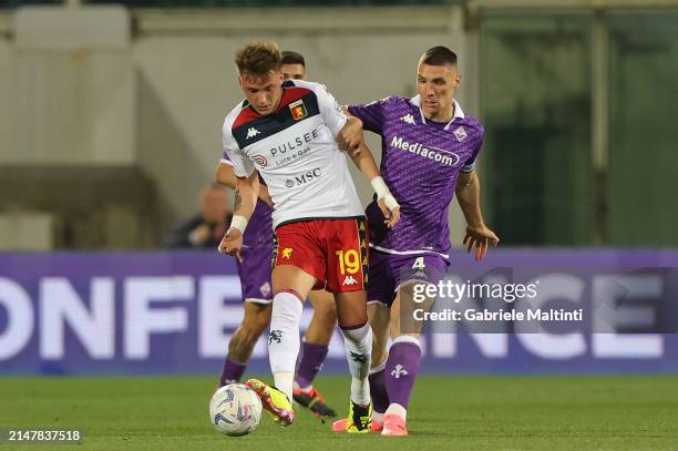 Mateo Retegui of Genoa CFC battles for the ball with Nikola Milenkovic of ACF Fiorentina during the Serie A TIM match between ACF Fiorentina and...