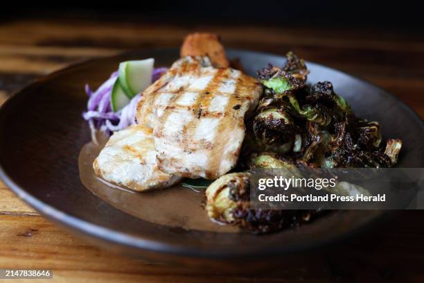 Bandaloop's sesame grilled chicken breast with crispy Brussel sprouts, pumpkin polenta fries and mole sauce.