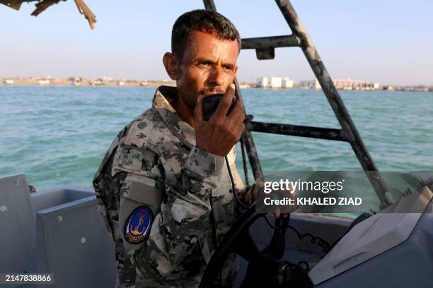 Member of Yemeni coastguard loyal to the internationally-recognised government communicates with a radio in a patrol boat in the Red Sea off the...