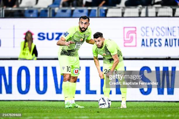 Himad ABDELLI and Farid EL MELALI of Angers during the Ligue 2 BKT match between Grenoble and Angers at Stade des Alpes on April 15, 2024 in...