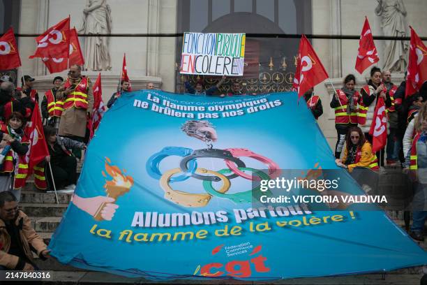 Banner saying "Let's light the flame of anger everywhere" at the CGT union torchlight march in Paris, France on April 15, 2024. The French union...