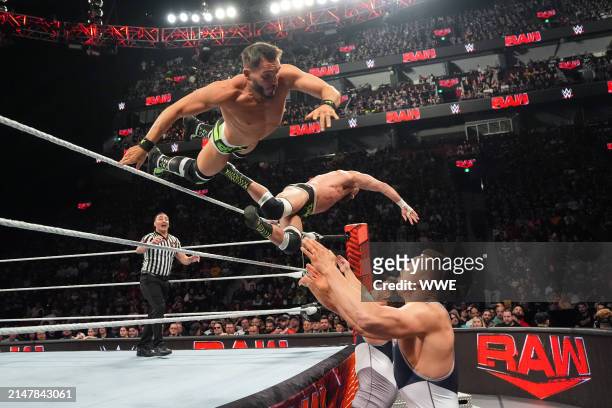Johnny Gargano and Tommaso Ciampa leap onto Julius Creed and Brutus Creed during Monday Night RAW at the Bell Centre on April 15, 2024 in Montreal,...