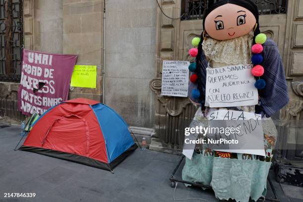 Indigenous communities are placing a doll outside the Government offices in Mexico City, demanding decent housing.