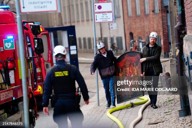 Of Danish Business, Brian Mikkelsen , and CFO of Danish Business, Philip Werner Willerslev-Olsen salvage a painting from the historic Boersen stock...