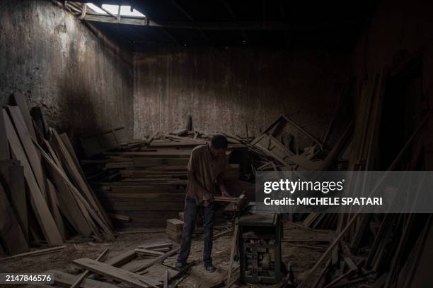 Carpenter works on a piece of a traditional Harari door at a workshop inside Harar walled city on April 15, 2024. Founded in the 10th century, Harar...