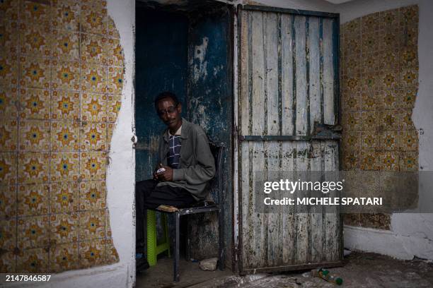 Man sits inside the Asmadin gate in Harar on April 15, 2024. Founded in the 10th century, Harar - also called Jugol - is reputed to be one of the...