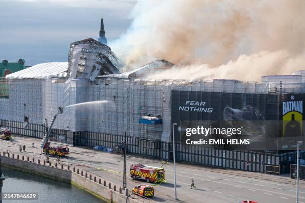 Plumes of smoke billow from the historic Boersen stock exchange building which is on fire in central Copenhagen, Denmark on April 16, 2024. A violent...