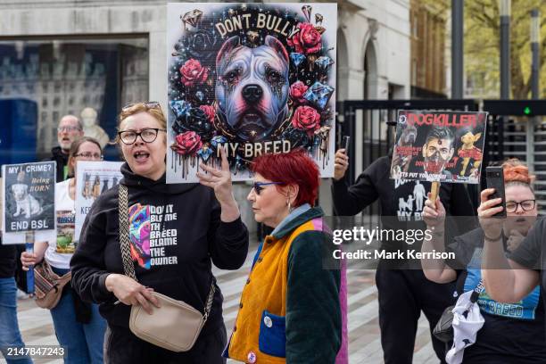 Animal rights activists holding signs protest outside New Scotland Yard against the shooting dead of XL Bully dogs by armed police officers on 13th...