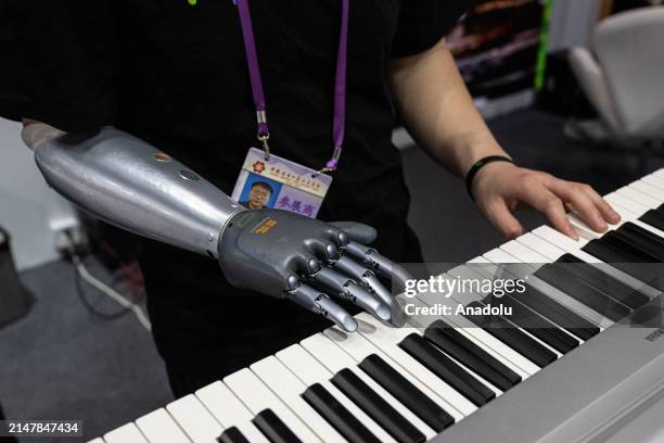 An exhibitor uses intelligent bionic hands to play piano during the 135th China Import and Export Fair on April 15, 2024 in Guangzhou, Guangdong...