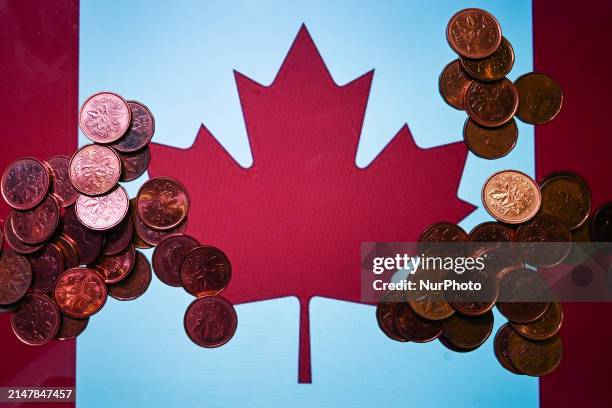 Illustrative photo featuring Canadian 1-cent coins with the Canadian flag displayed on a computer screen in the background, on April 15 in Edmonton,...