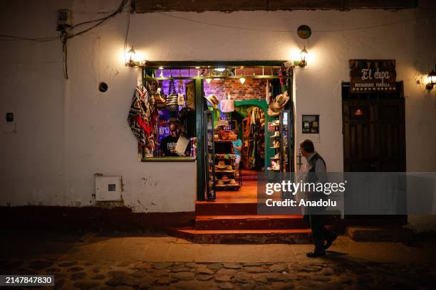 Tourists and locals enjoy dining and strolling through the town located in Boyaca Department, Colombia of the main plaza or square in Villa de Leyva,...