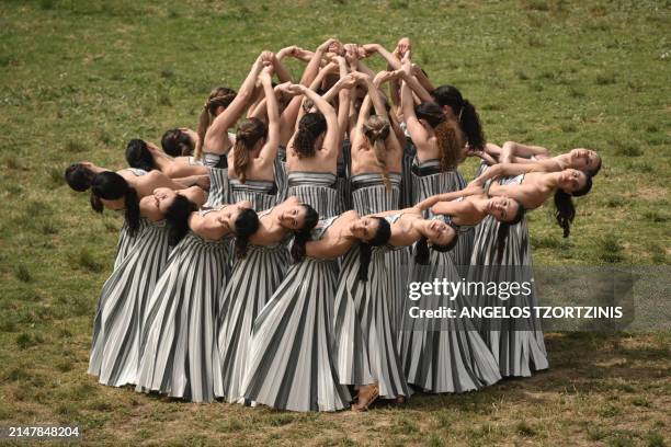 Actresses perform during the Olympic flame lighting ceremony for the Paris 2024 Olympics Games at the Ancient Olympia archeological site, birthplace...