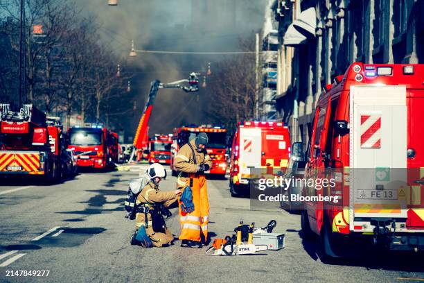 Firefighters prepare to tackle a fire at Borsen, Denmark's old stock exchange building, in Copenhagen, Denmark, on Tuesday, April 16, 2024. The fire...