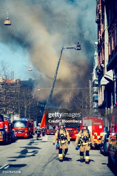 Firefighters tackle a fire at Borsen, Denmark's old stock exchange building, in Copenhagen, Denmark, on Tuesday, April 16, 2024. The fire has torn...