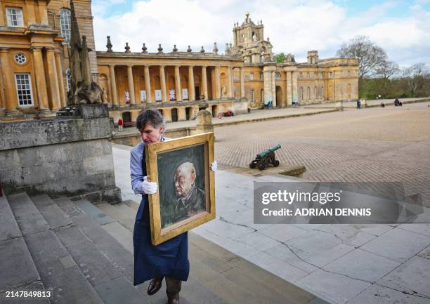 Matthew Floris, a Sotheby's employee poses with a portrait, a surviving study of Winston Churchill, at Blenheim Palace, north of Oxford, home to the...