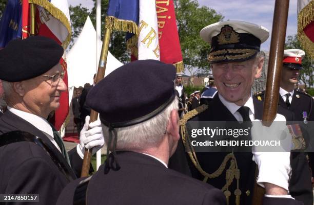 Prince Philip, Duke of Edimburgh salutes French veterans after the inauguration, 06 June 2000 in Ouistreham, in Normandy, of a war memorial erected...