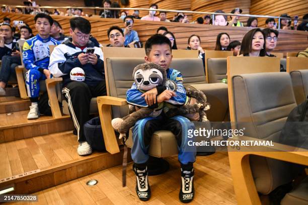 Boy wearing a racing outfit attends to the world premiere of the docu-film The First One about the Formula 1 Kick Sauber's Chinese driver Zhou...