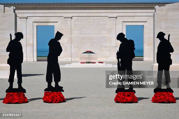 This photograph taken on April 12, 2024 shows cutting board silhouettes of British soldiers installed as part of the "Standing with Giants"...