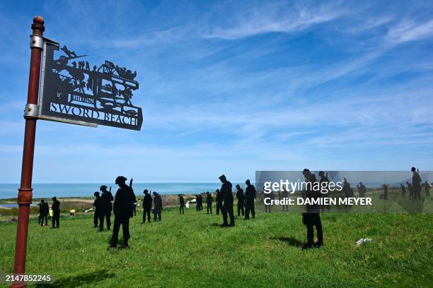 This photograph taken on April 12, 2024 shows cutting board silhouettes of soldiers installed as part of the "Standing with Giants" installation at...