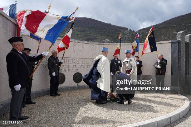 France's President Emmanuel Macron lays flowers during an unprecedented tribute ceremony for the Vercors resistance fighters and civilian victims as...