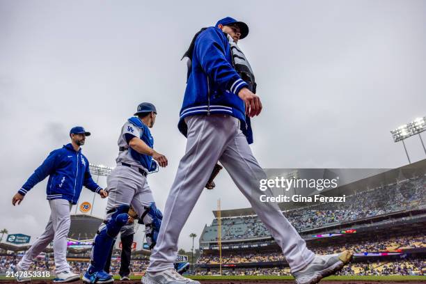 Dodgers starting pitcher James Paxton walks with catcher Will Smith to the dugout before the game against the San Diego Padres at Dodger Stadium on...