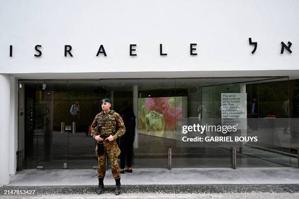 An Italian soldier stands guard in front of Israel's pavilion during the pre-opening of the Venice Biennale art show, on April 16, 2024 in Venice....