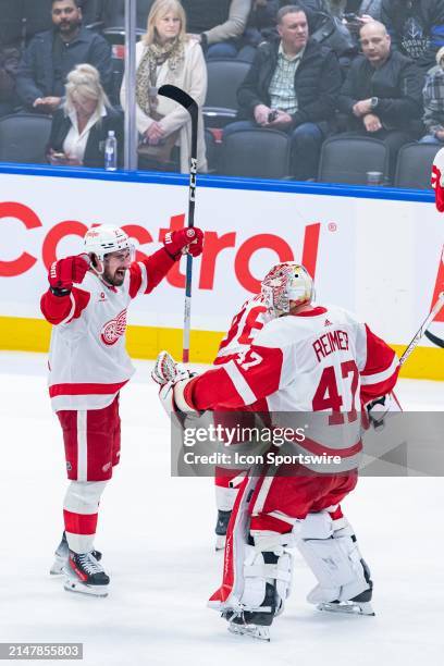 Detroit Red Wings Center Dylan Larkin celebrates the win with Detroit Red Wings Goalie James Reimer after the NHL regular season game between the...