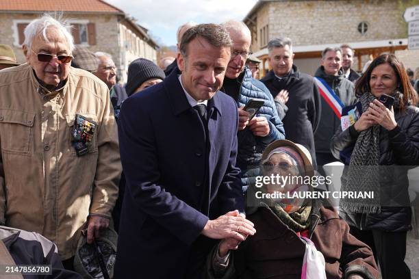 French President Emmanuel Macron greets Yvonne Cheval who lost part of her family during WWII, during the commemorations of the 80th anniversary of...