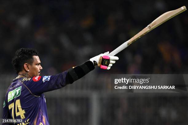 Kolkata Knight Riders' Sunil Narine celebrates after scoring a century during the Indian Premier League Twenty20 cricket match between Kolkata Knight...