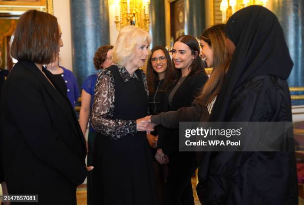 Queen Camilla, Patron of SafeLives, meets with young pioneer 'Changemakers', from the SafeLives charity at Buckingham Palace on April 16, 2024 in...