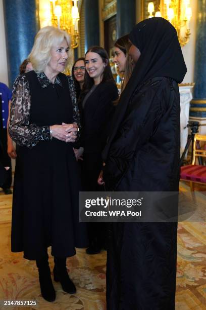 Queen Camilla, Patron of SafeLives, meets with young pioneer 'Changemakers', from the SafeLives charity at Buckingham Palace on April 16, 2024 in...