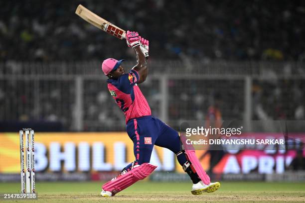 Rajasthan Royals' Rovman Powell watches the ball after playing a shot during the Indian Premier League Twenty20 cricket match between Kolkata Knight...